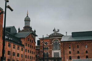 Majestic historic buildings of Carlsberg Brewery in Denmark during a cloudy day.