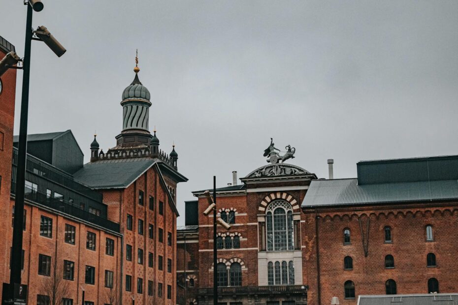 Majestic historic buildings of Carlsberg Brewery in Denmark during a cloudy day.