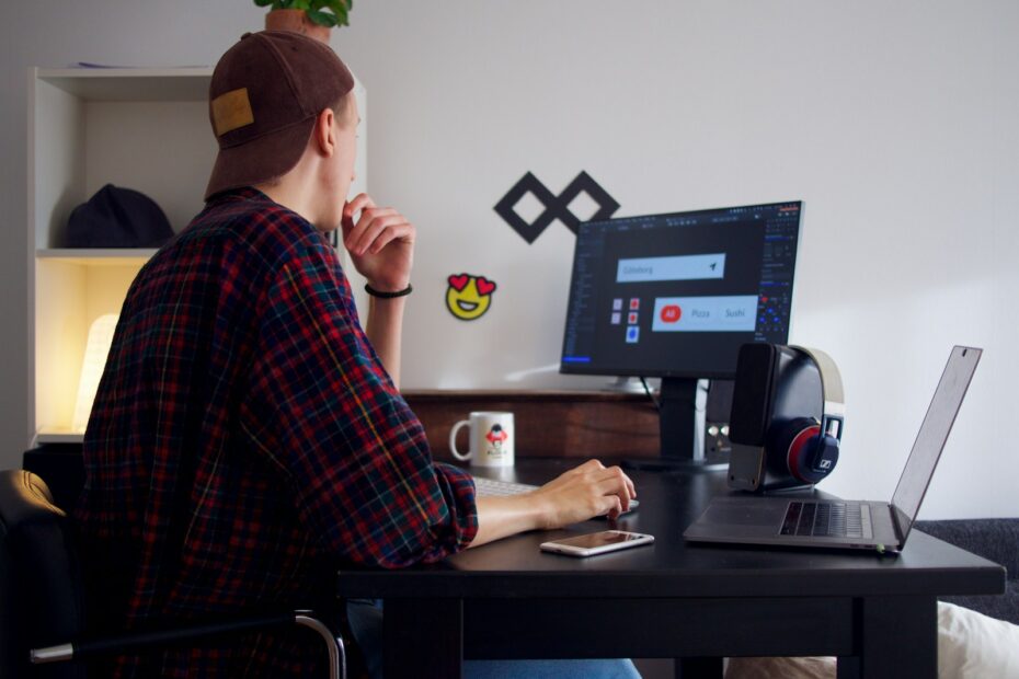 man sitting near table using computer