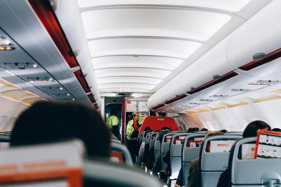 the inside of an airplane with people sitting on the seats